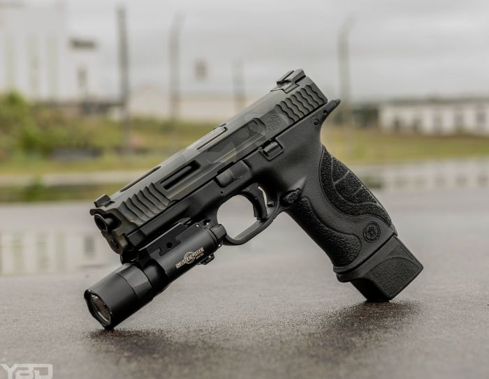 A custom Smith and Wesson M&P9 with a custom slide from Loki Tactical with an Apex Tactical Trigger and Surefire X-300u light.
