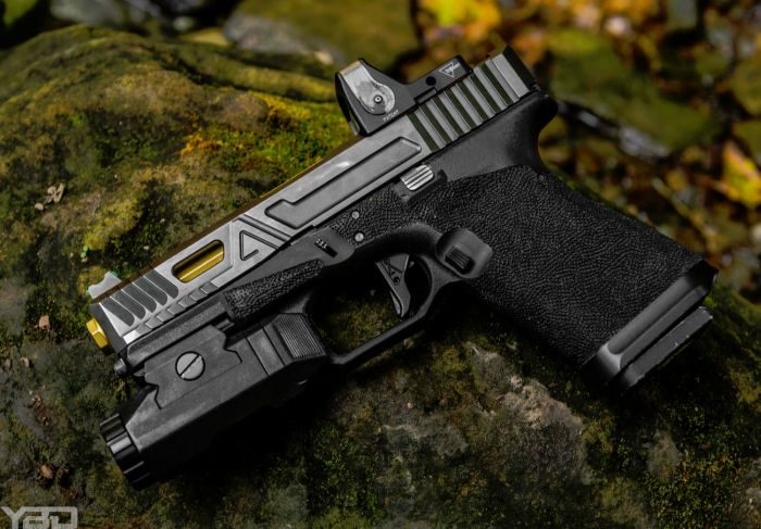 An Agency Arms Gen 3 Glock 19 with a Trijicon RMR and Inforce APL flashlight.