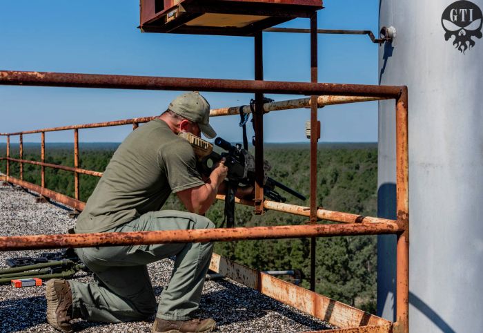 Sniper students practicing high angle elevated shooting while on the roof top of our sniper tower.