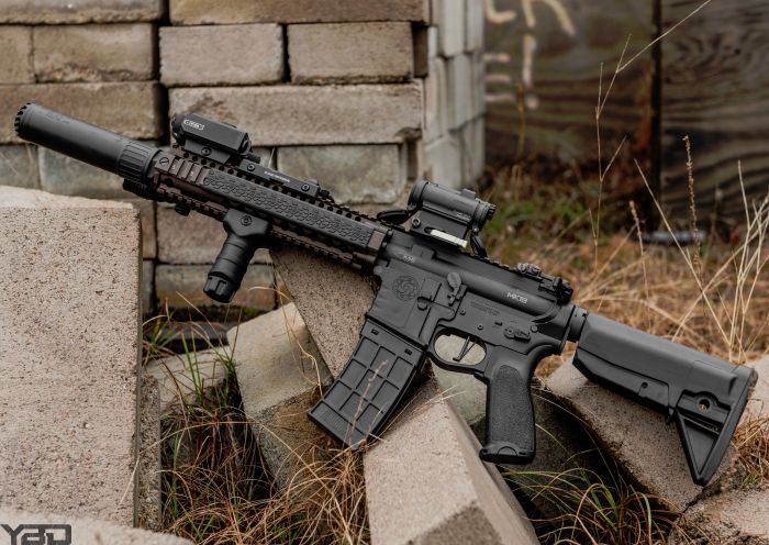 A Daniel Defense MK18 with an OSS Suppressor, Aimpoint COMP M5, Holosun Laser Aiming Device, and Streamlight Protac HL-X weapon mounted light.