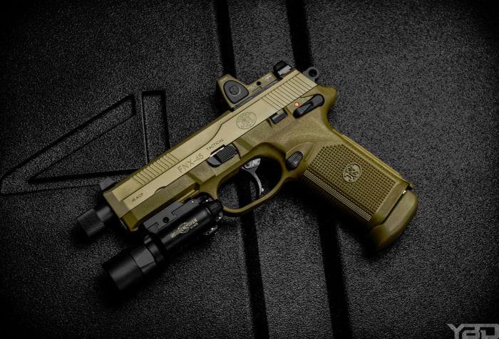 The FNX-45 Tactical decked out with a Trijicon RMR and Surefire X-300u light.